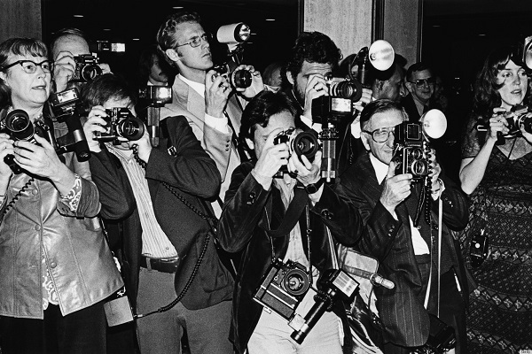 LOS ANGELES - 1979:  A crowd of paparazzi struggle to take photos of arriving musical celebrity at the annual Grammy Awards in Los Angeles, California. (Photo by George Rose/Getty Images)